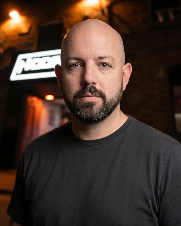 A portrait of John, who runs hosting at Hidden Burnley, photographed near the venue entrance.