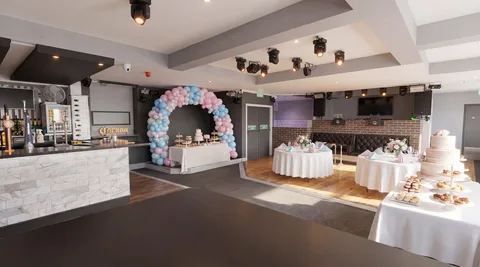 Hidden Burnley in daytime soft light with a pastel balloon arch and dessert table.