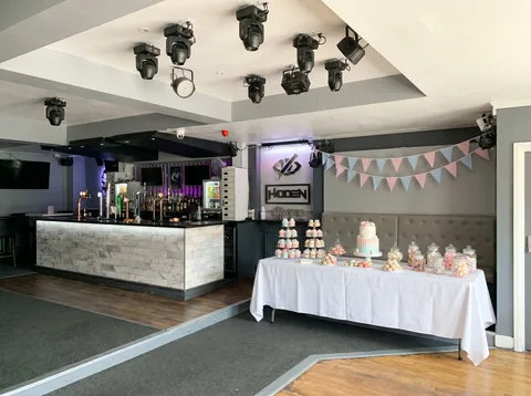 Long dessert table set against the booth wall at Hidden Burnley for a baby shower.