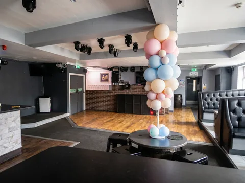 Tall pastel balloon cluster centrepiece in pink, blue and cream at Hidden Burnley.