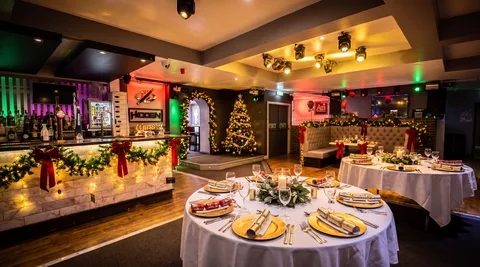 Hidden Burnley dressed for a corporate Christmas party with garland, ribbon and round tables.