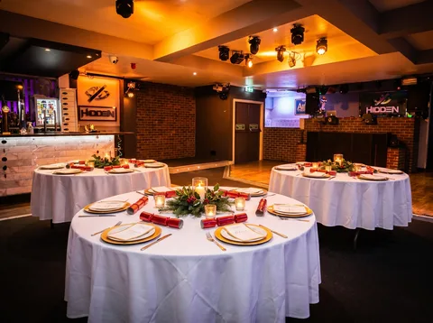 Round tables laid for a corporate Christmas dinner at Hidden Burnley.