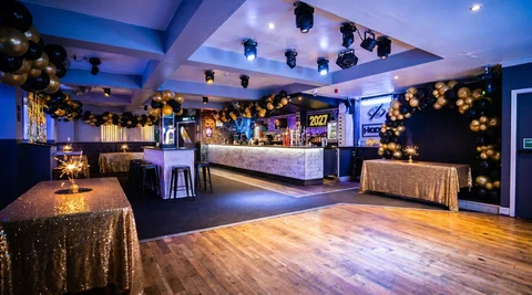 Hidden Burnley dressed for New Year's Eve with black-and-gold balloon clusters.