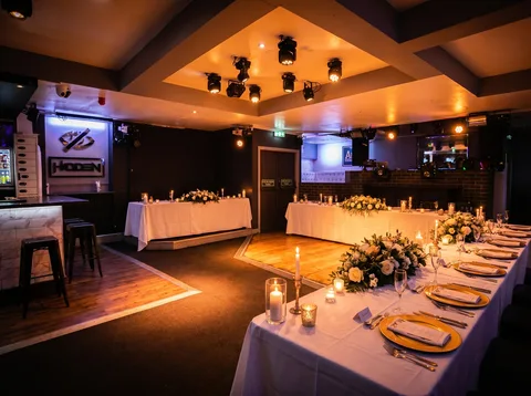Top-table laid for a wedding reception along the back wall at Hidden Burnley.