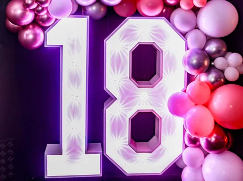 Bar at Hidden Burnley lit pink with balloon-letter PARTY decoration during a private hire.
