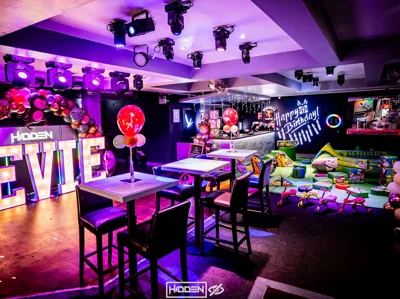 Dance floor at Hidden Burnley with magenta uplighting and balloon decor.