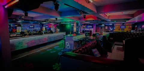 Empty interior of Hidden Burnley with PAR-can stage lighting overhead.